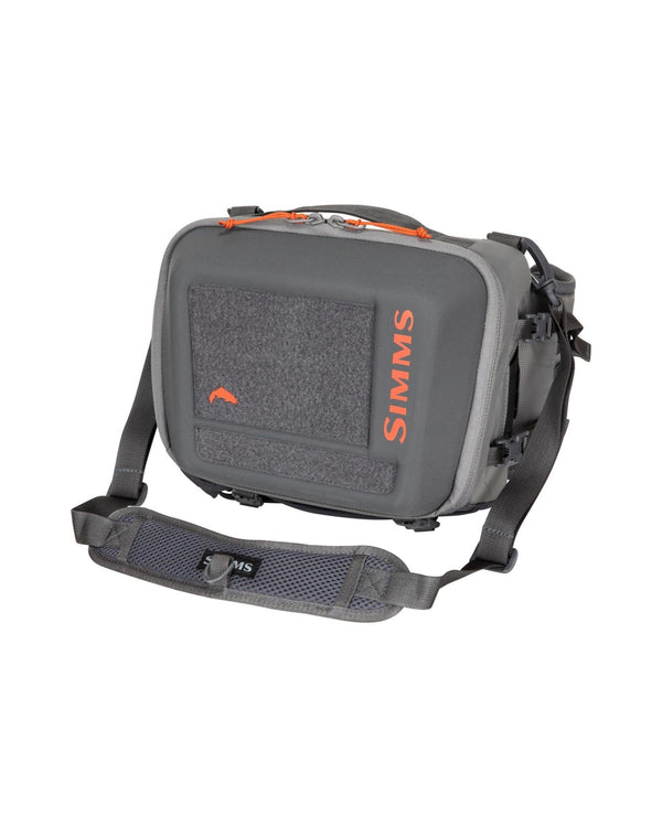 Simms Freestone® Hip Pack showcasing multiple compartments, adjustable waist strap, and durable construction, ideal for carrying fishing gear comfortably during outdoor adventures.