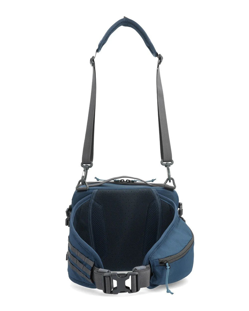 Simms Freestone® Hip Pack showcasing multiple compartments, adjustable waist strap, and durable construction, ideal for carrying fishing gear comfortably during outdoor adventures.