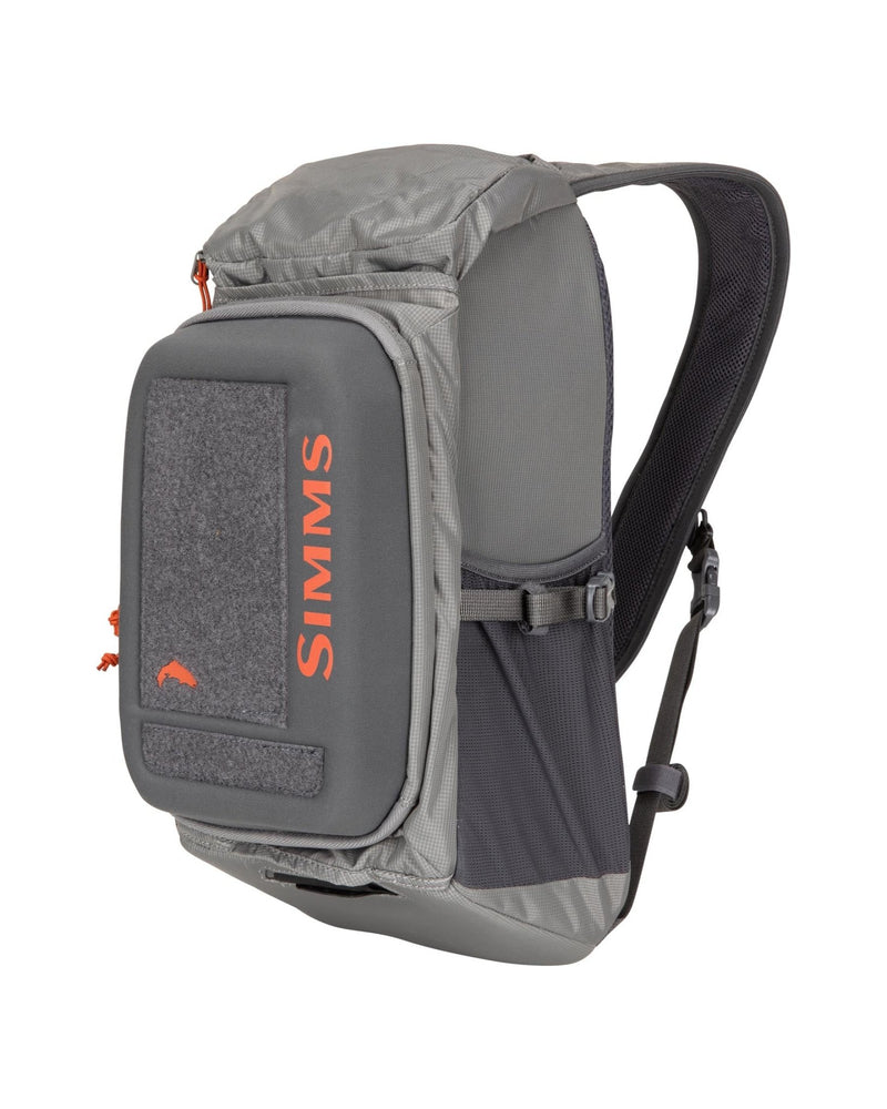 Simms Freestone® Sling Pack featuring a durable design, multiple compartments, and adjustable strap, ideal for carrying fishing essentials securely and comfortably during outdoor excursions.