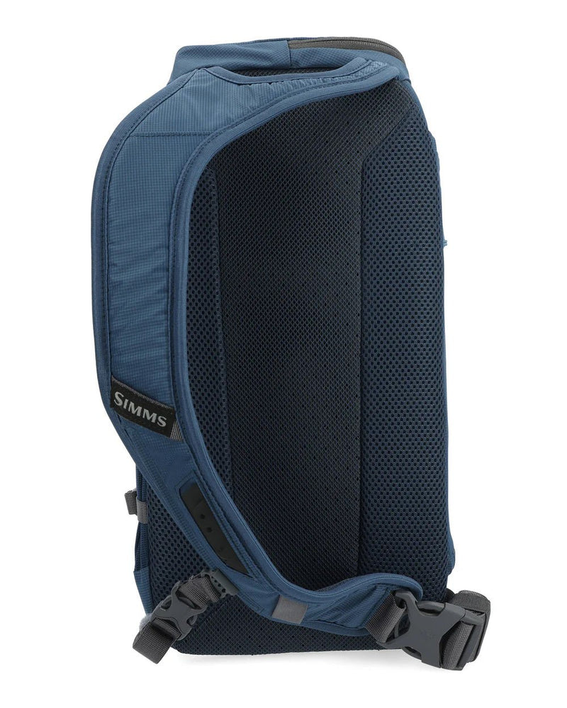 Simms Freestone® Sling Pack featuring a durable design, multiple compartments, and adjustable strap, ideal for carrying fishing essentials securely and comfortably during outdoor excursions.