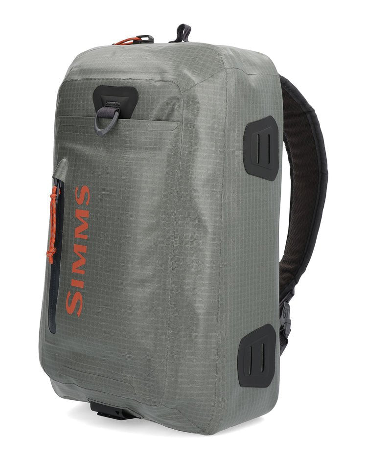  Simms Dry Creek Z Sling Pack featuring waterproof fabric, multiple compartments, and an adjustable strap, perfect for securely carrying fishing gear during outdoor adventures.